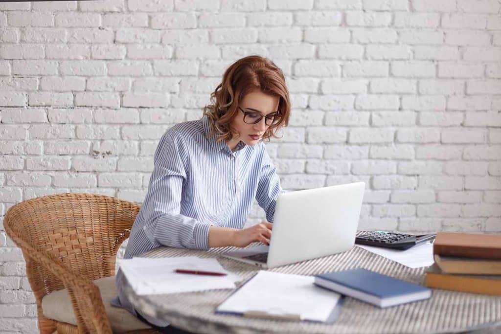 Young woman freelancer works at the computer.