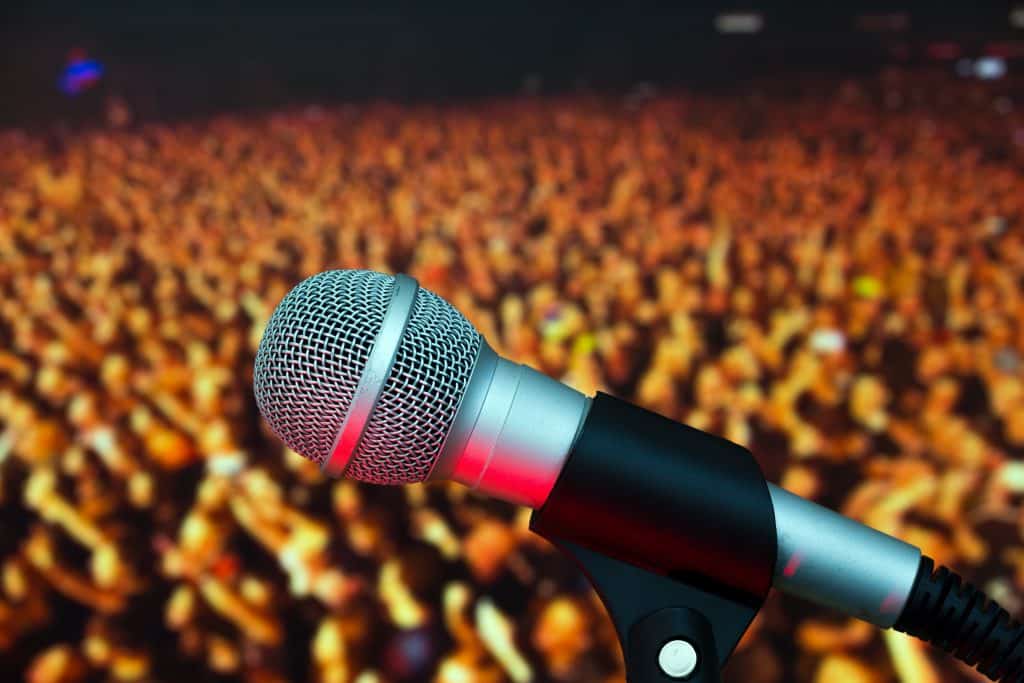 Microphone on stage on the background of people during the conce