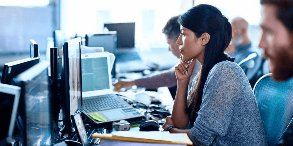 woman reviewing data on computer in office blog header