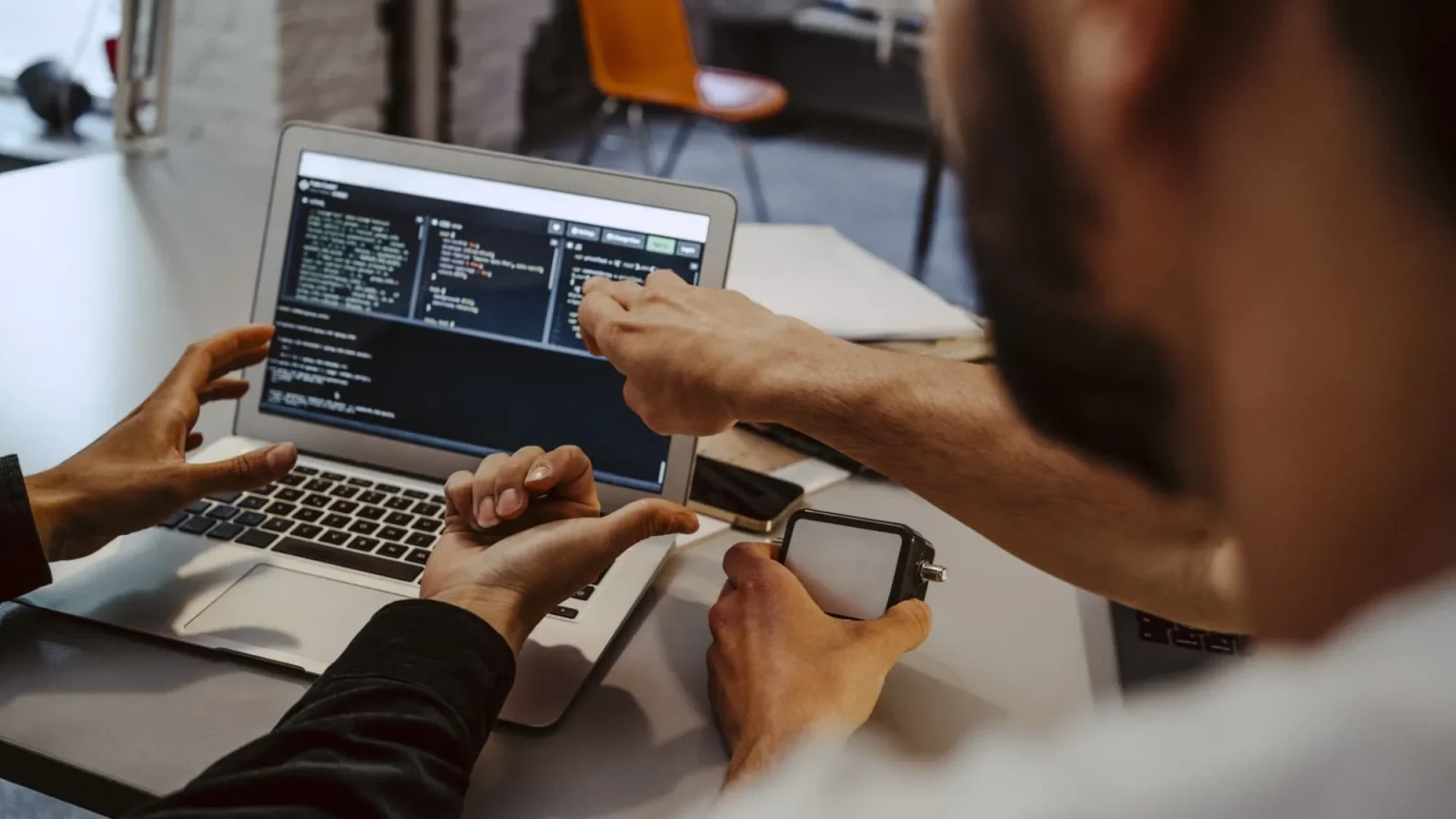 Two people coding laptop office b